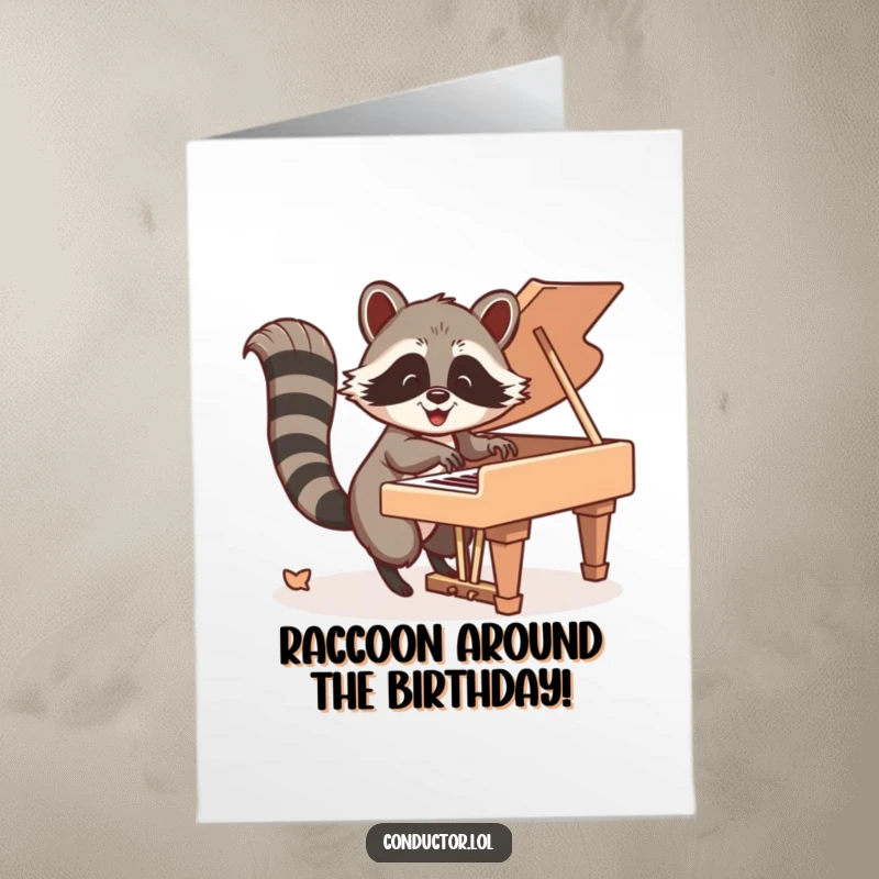 Funny free printable birthday card: Happy raccoon energetically taps piano keys with its tail, a musical birthday celebration.